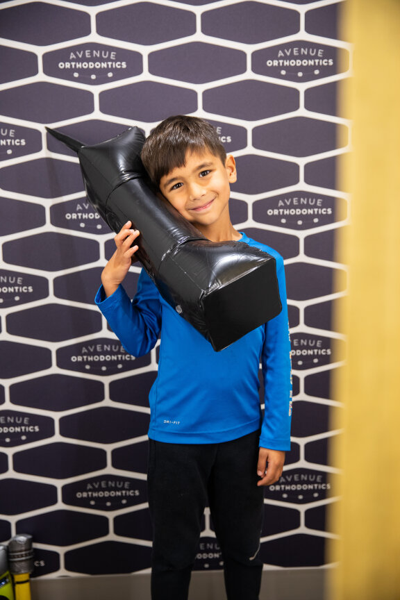 Child Holding Inflatable Phone